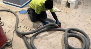 Basement Hand Grinding Failed Epoxy Concrete Coating